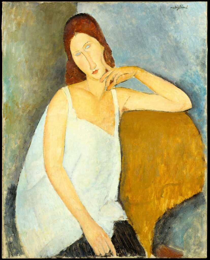 モディリアーニ《ジャンヌ・エビュテルヌ》1919年。白い衣服で頬に手を添える女性、メトロポリタン美術館